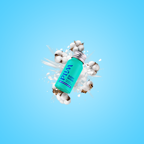 Caption: a bottle of deodorant sitting on top of a pile of cotton balls