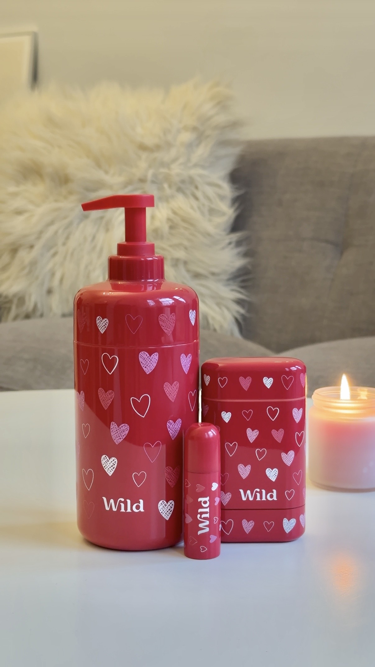 Caption: a table with a candle, soap dispenser, and soap disp