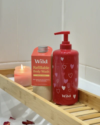 Caption: a bottle of soap and a soap dispenser on a wooden shelf