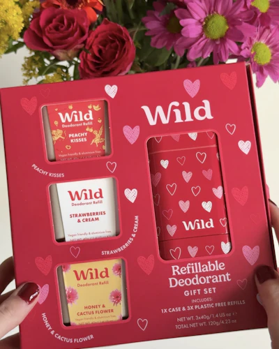 Caption: a person holding a box of wild products