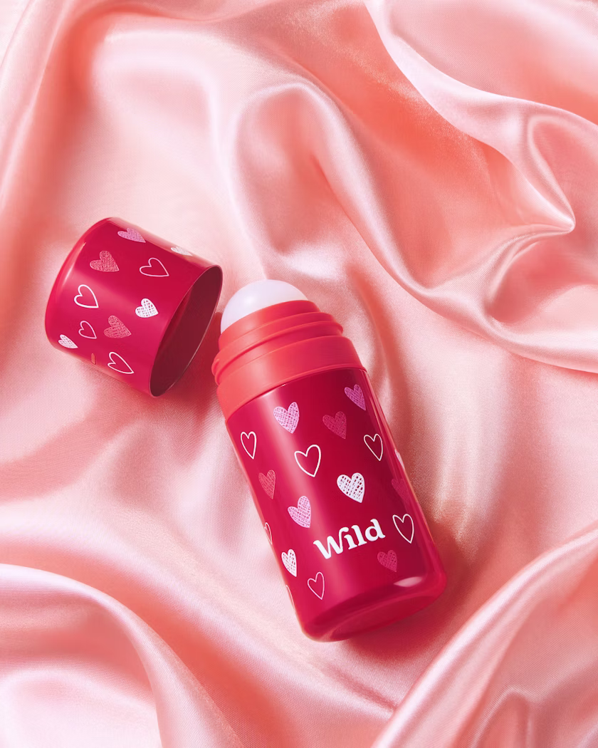 Caption: a couple of lipstick bottles sitting on top of a pink cloth