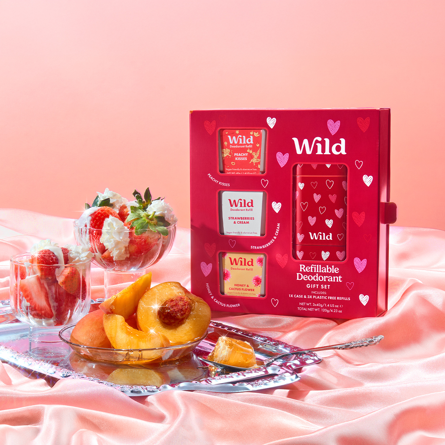 Caption: a table topped with a bowl of fruit next to a box of wild