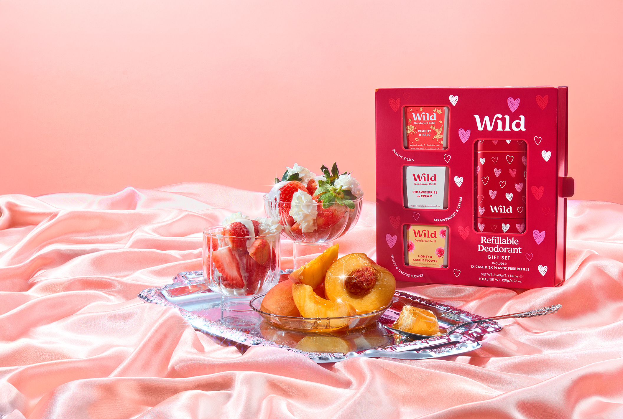 Caption: a table topped with a bowl of fruit next to a box of wild