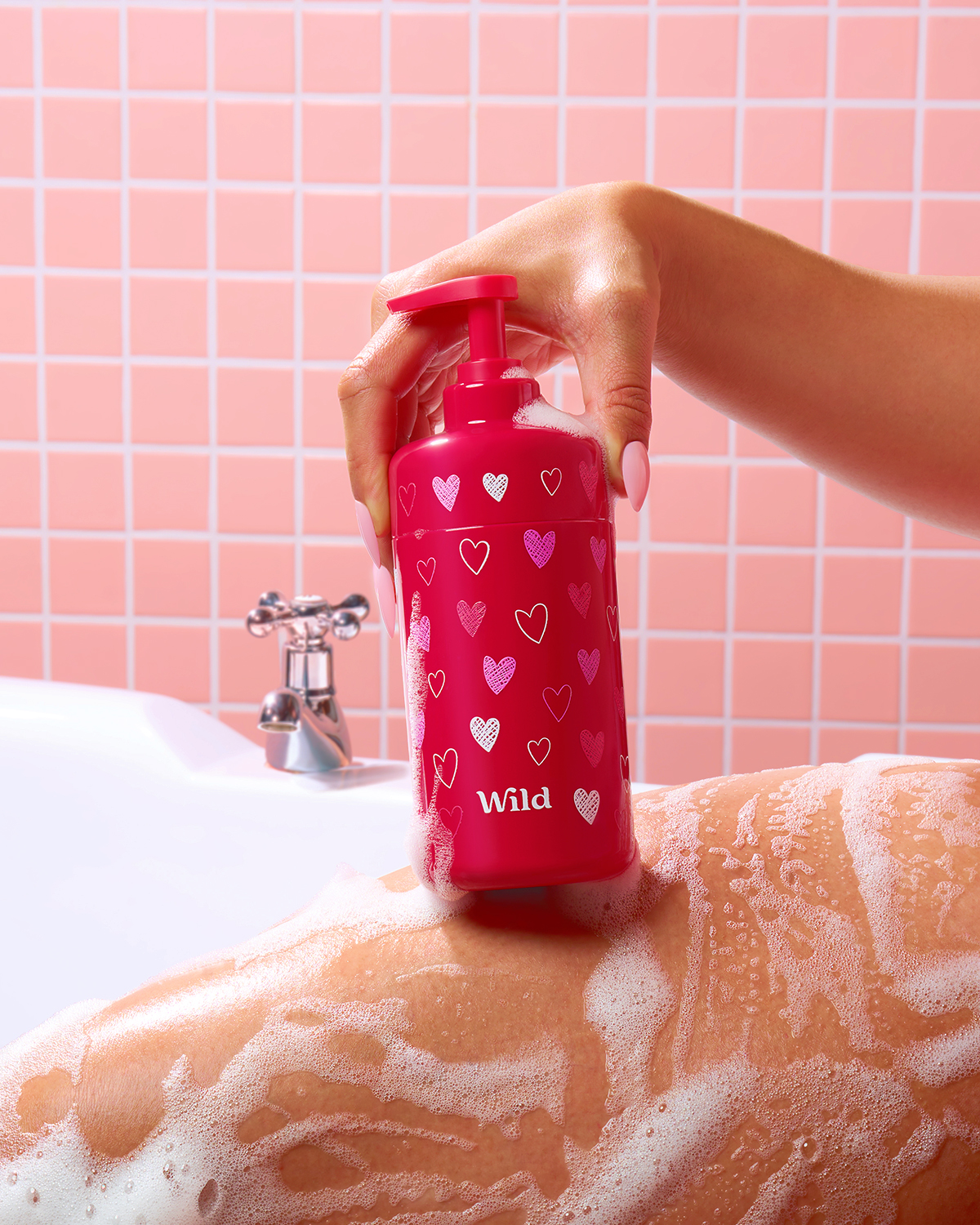 Caption: a person holding a pink water bottle in a bathroom