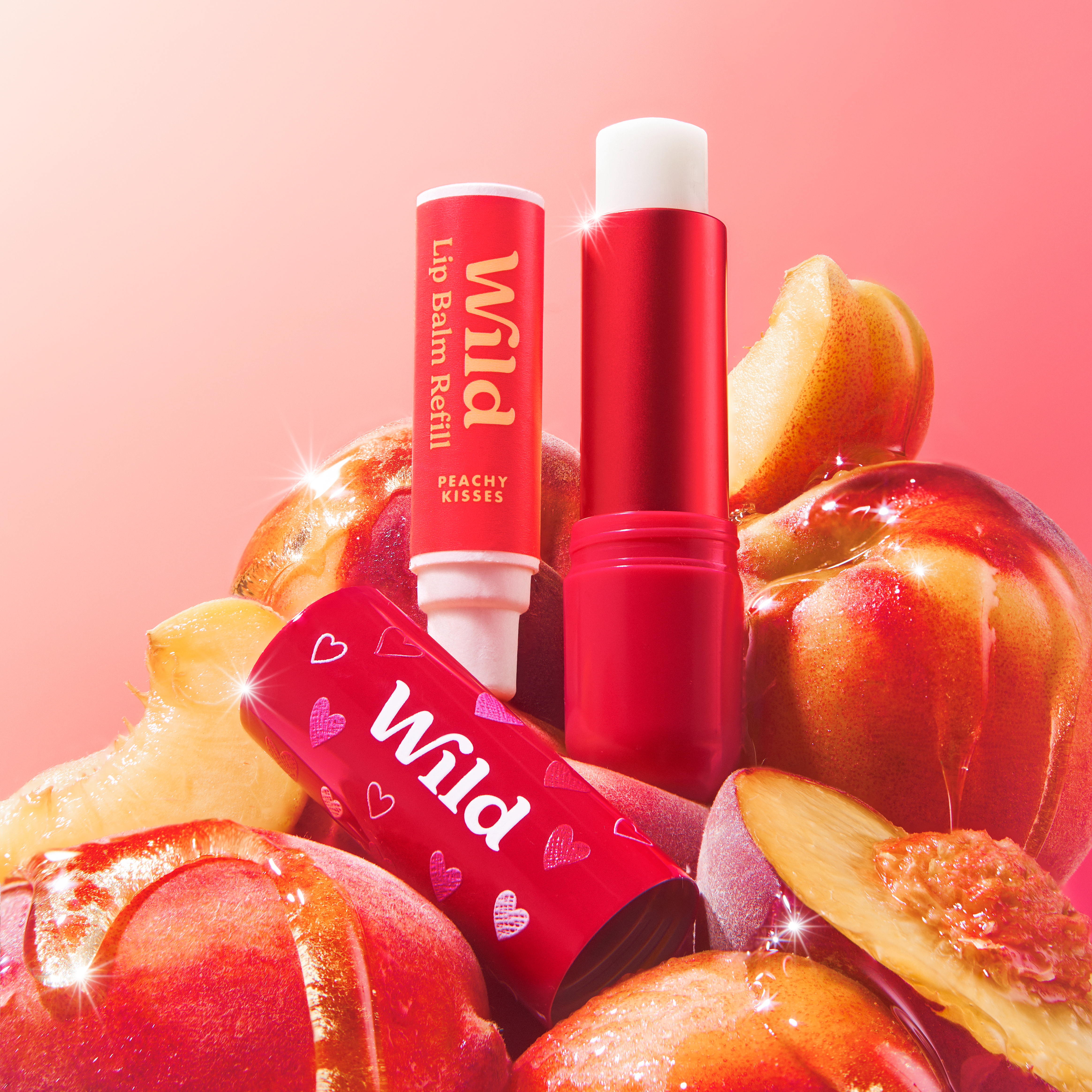 Caption: a couple of lip balms sitting on top of apples