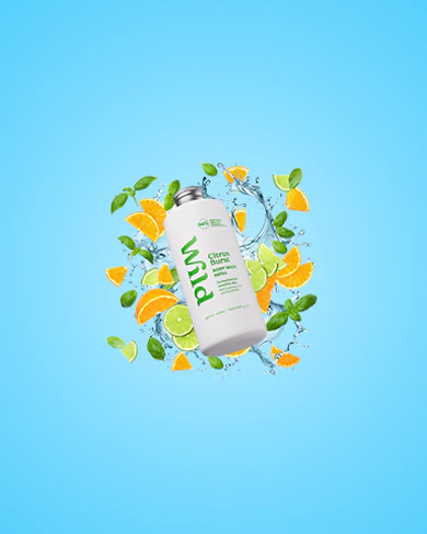 Caption: a bottle of green juice surrounded by oranges and leaves