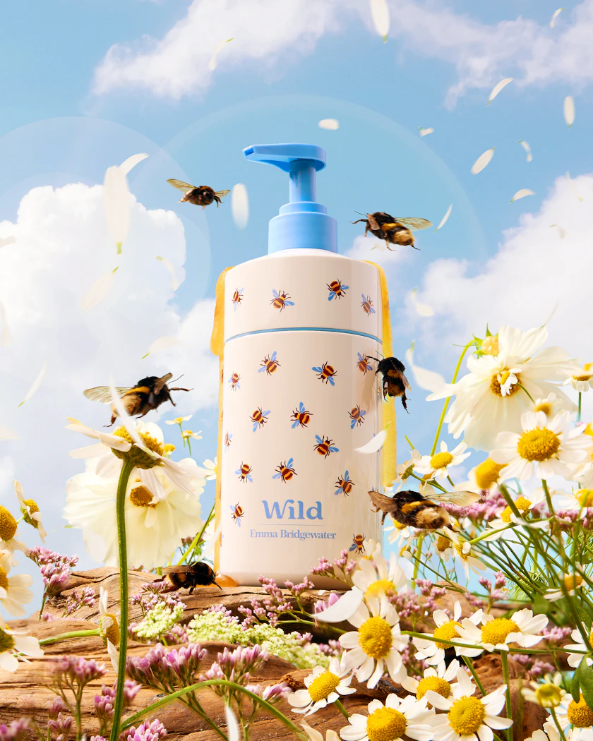 Caption: a bottle with a blue lid sitting on top of a field of flowers