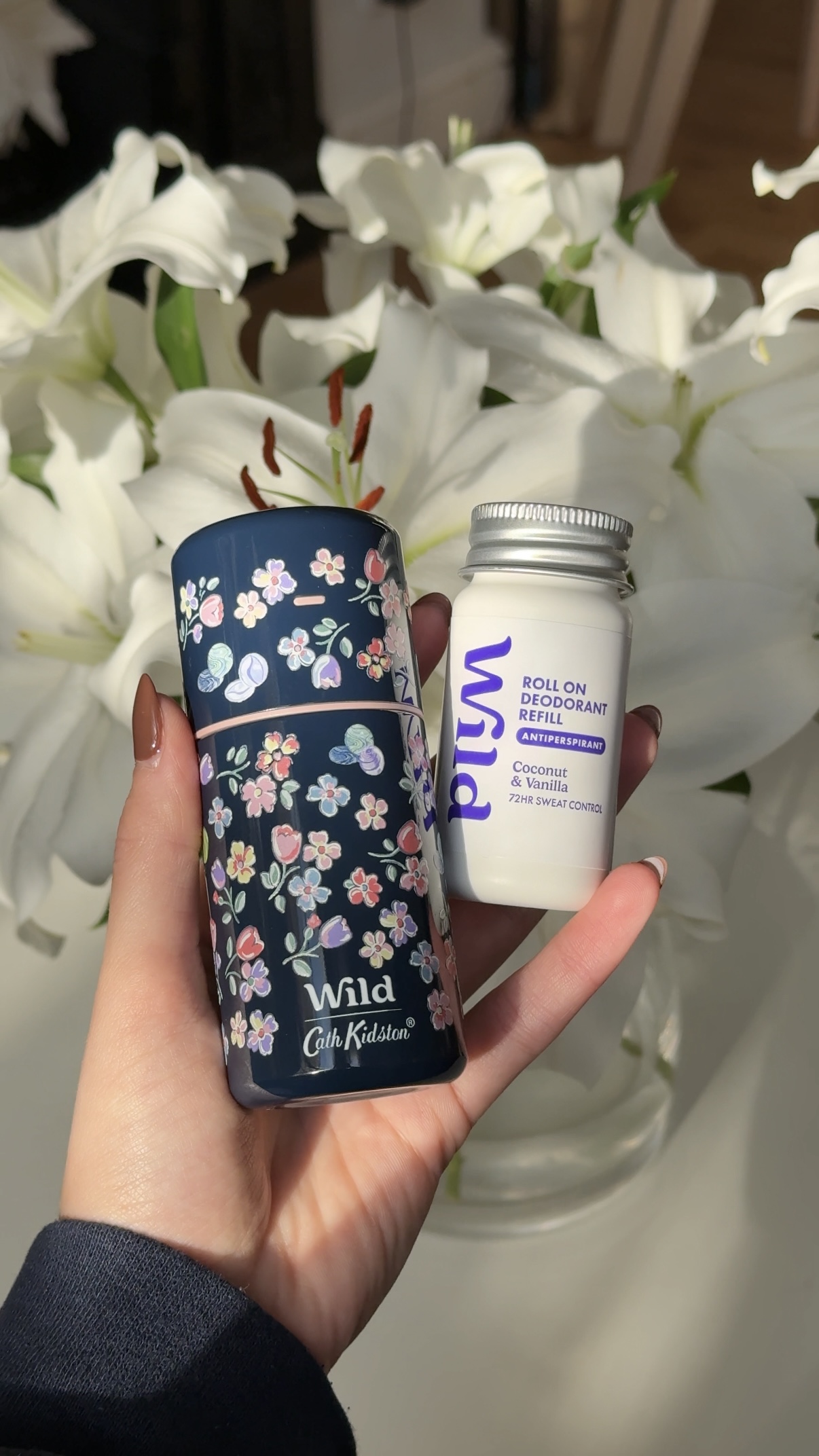 Caption: a person holding a jar of white flowers