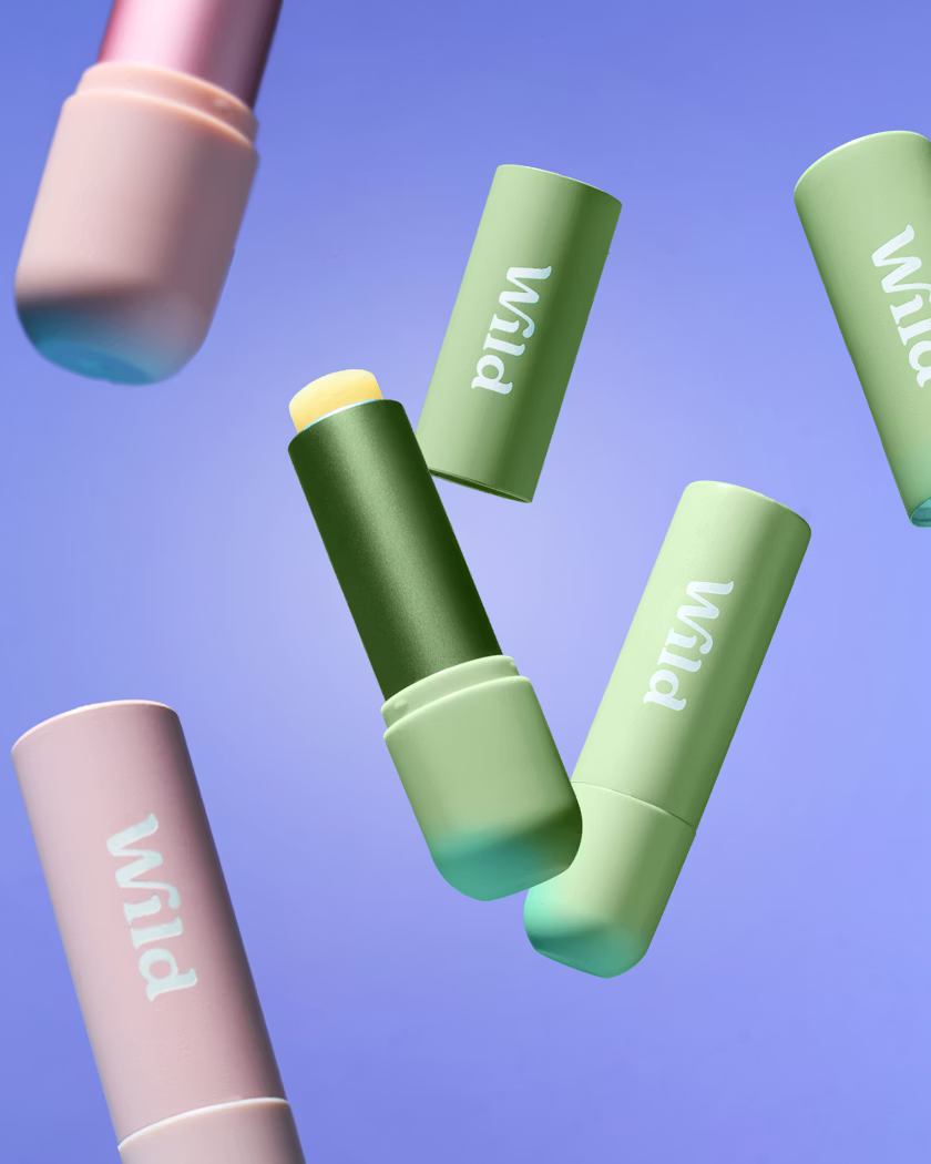 Caption: a group of three green and pink lipsticks flying through the air