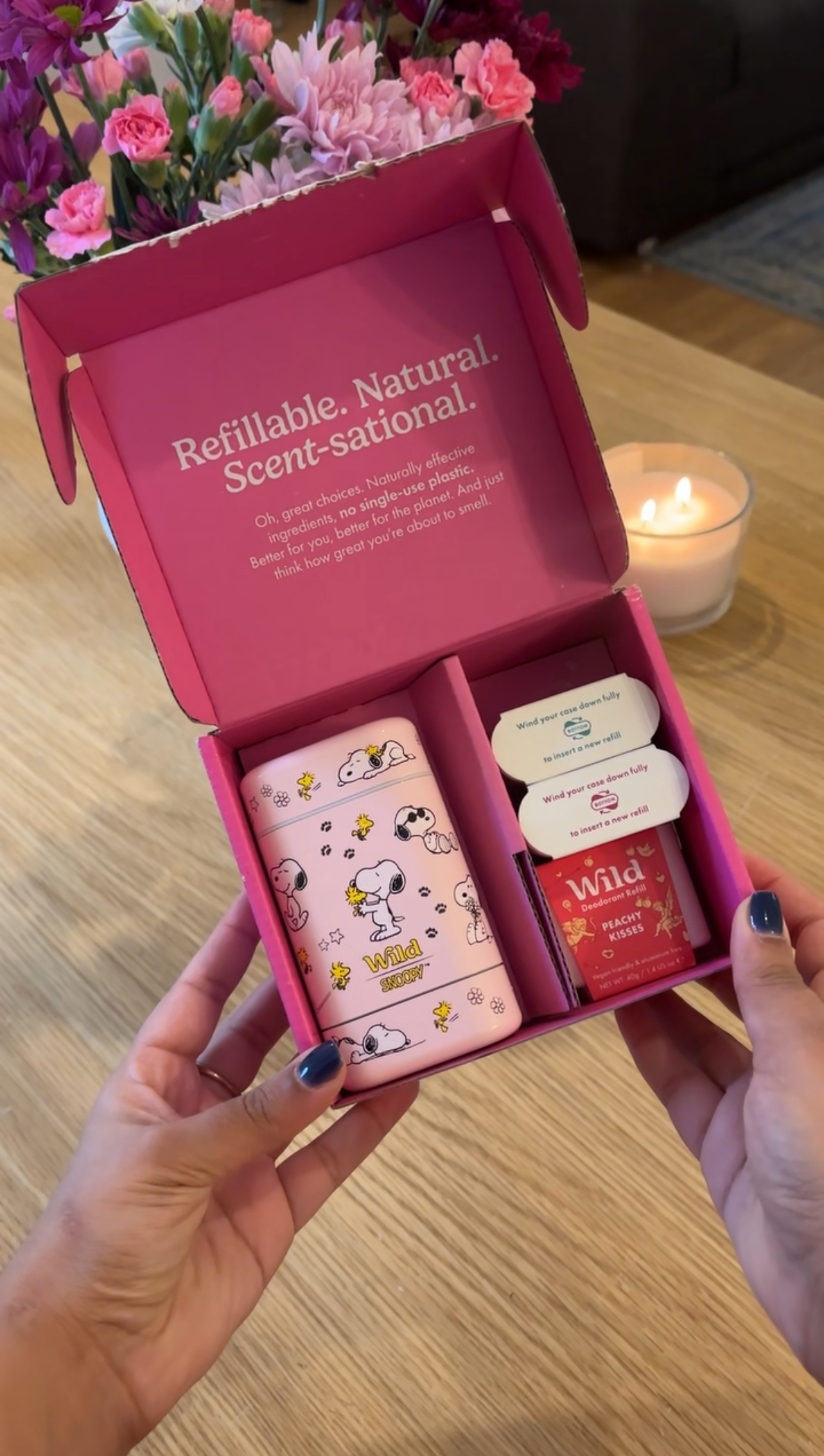 Caption: a person holding a pink box with some skin care products in it