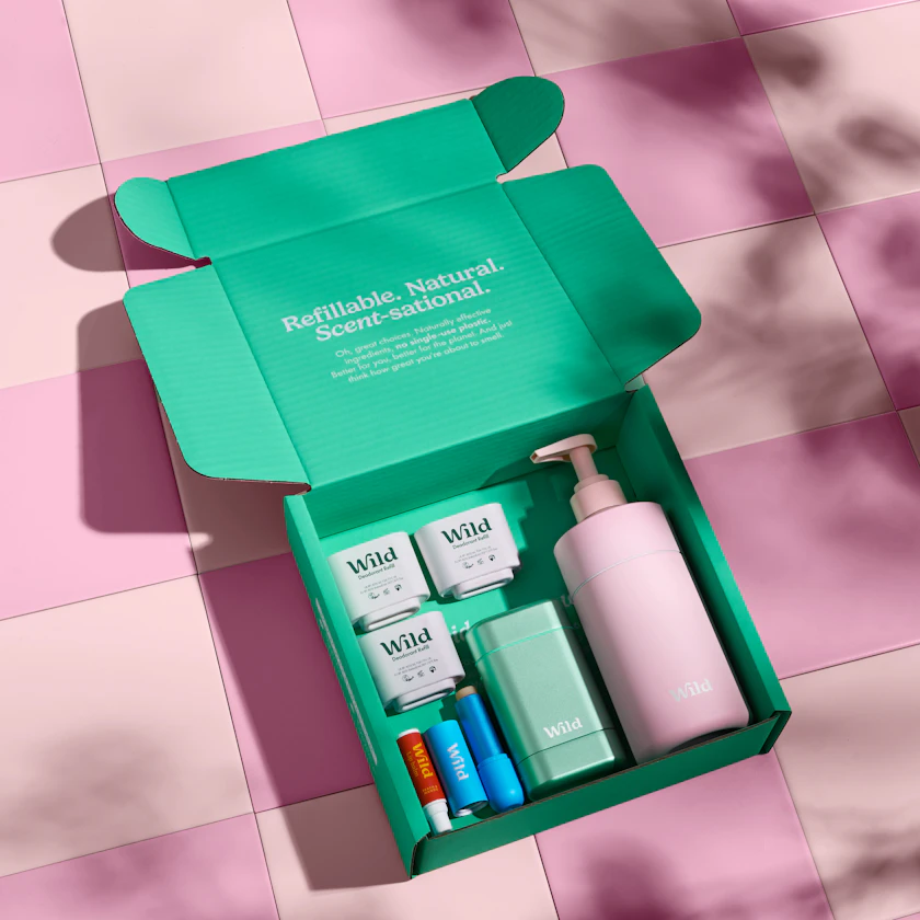 Caption: a green box containing a lotion and a lotion bottle