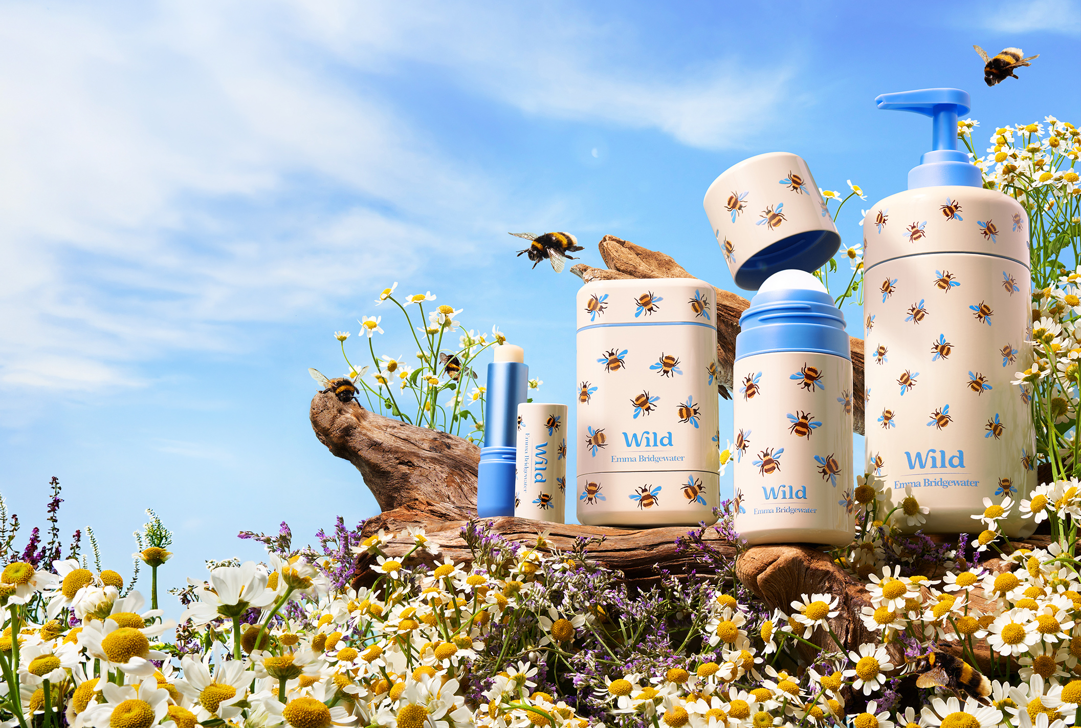 Caption: a bunch of blue and white containers sitting in a field of flowers