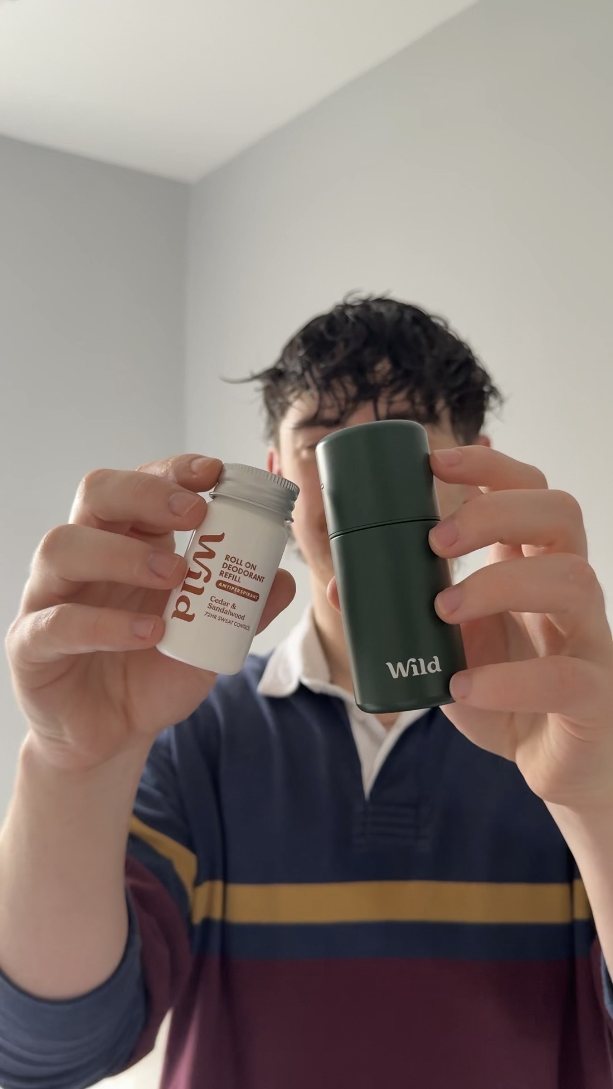 Caption: a man holding a cup of coffee in front of his face