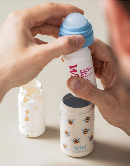 Caption: a person holding a baby bottle in their hand