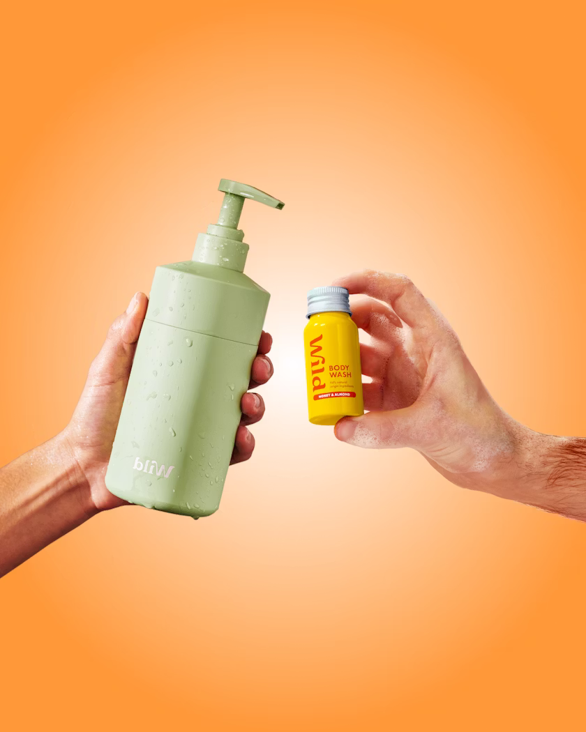 Caption: two hands holding a bottle of soap and a hand sanitizer