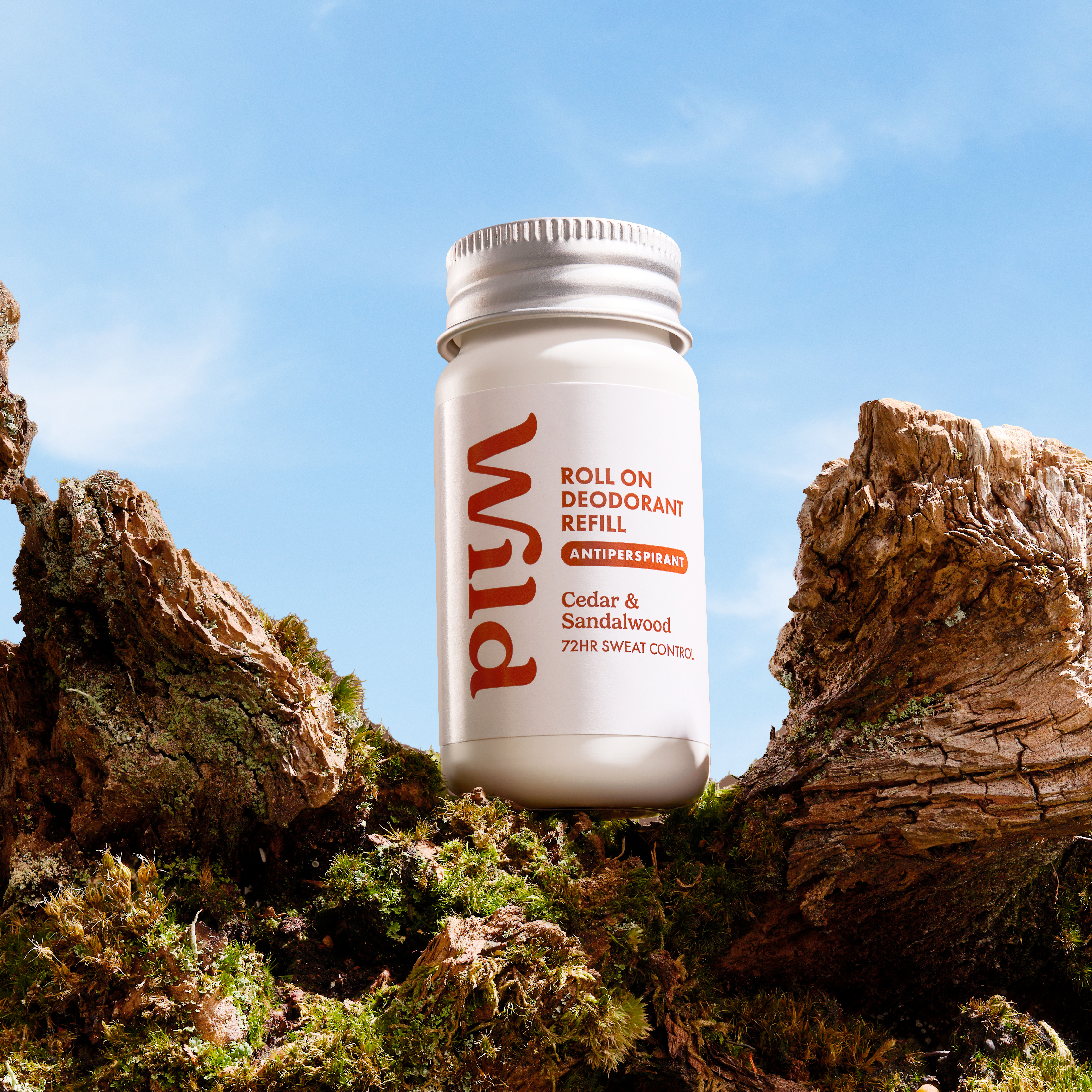 Caption: a bottle of rum sitting on top of a tree stump