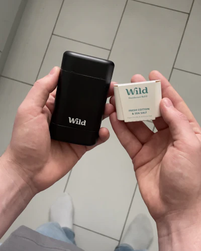 Caption: a person holding a cell phone in their hands