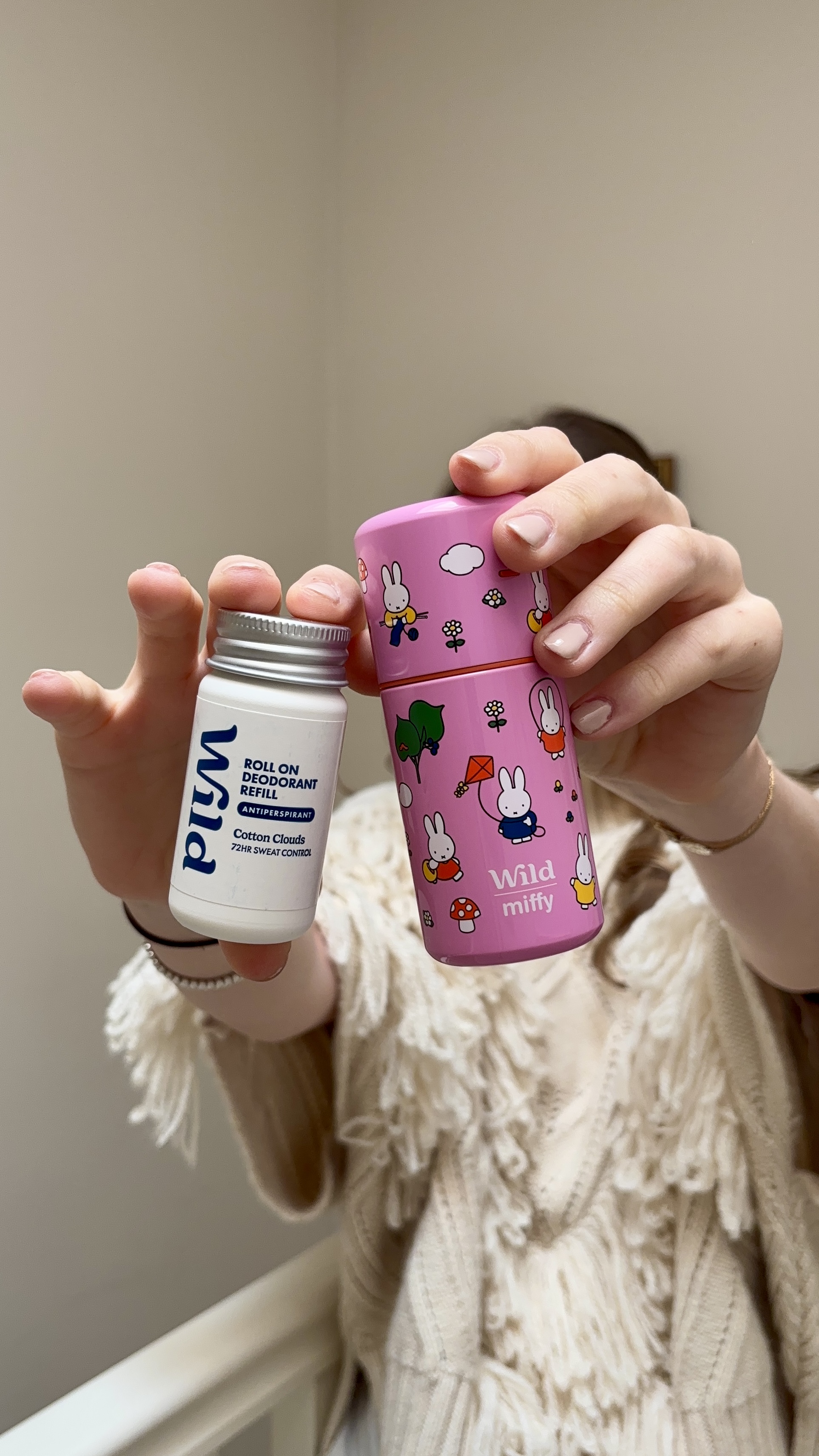 Caption: a woman holding a pink cup and a pink and white cup
