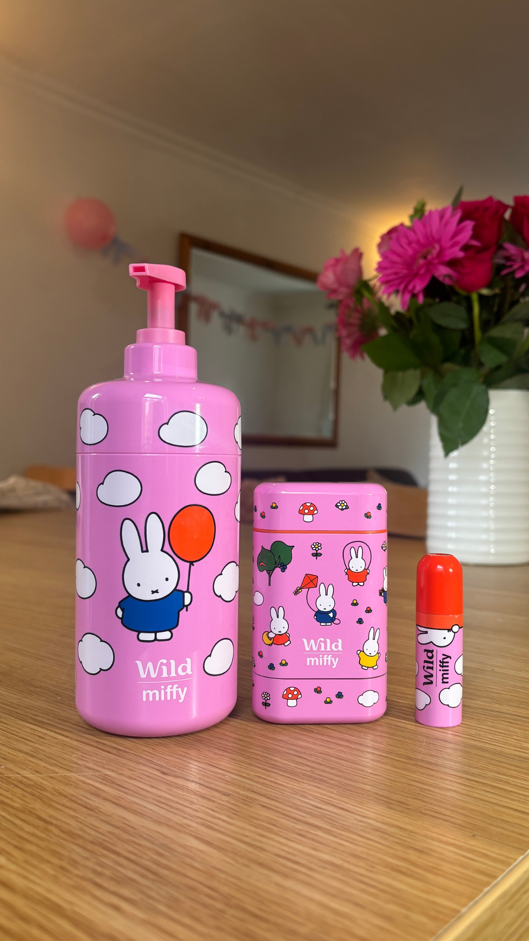 Caption: a bottle of lotion and a container of lip balm on a table