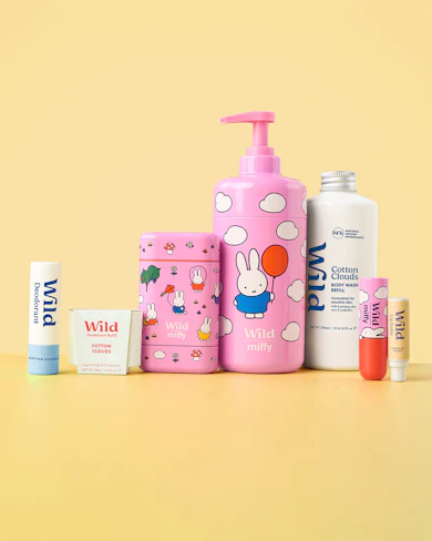 Caption: a yellow table with a bottle of lotion and a tube of toothpaste
