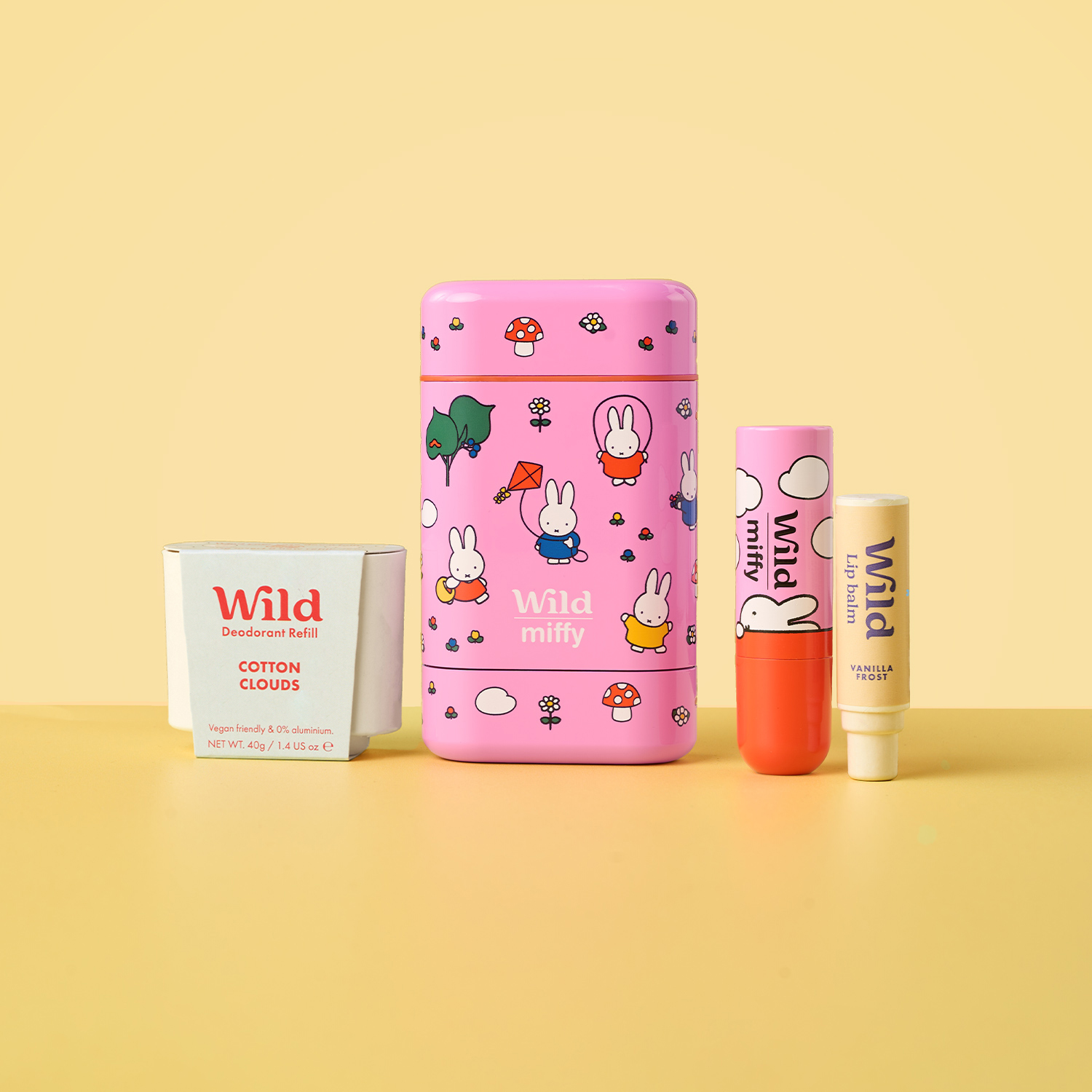 Caption: a pink box with a bunny pattern on it next to a tube of lip butter