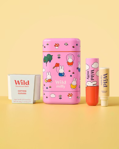 Caption: a pink box with a bunny pattern on it next to a tube of lip butter