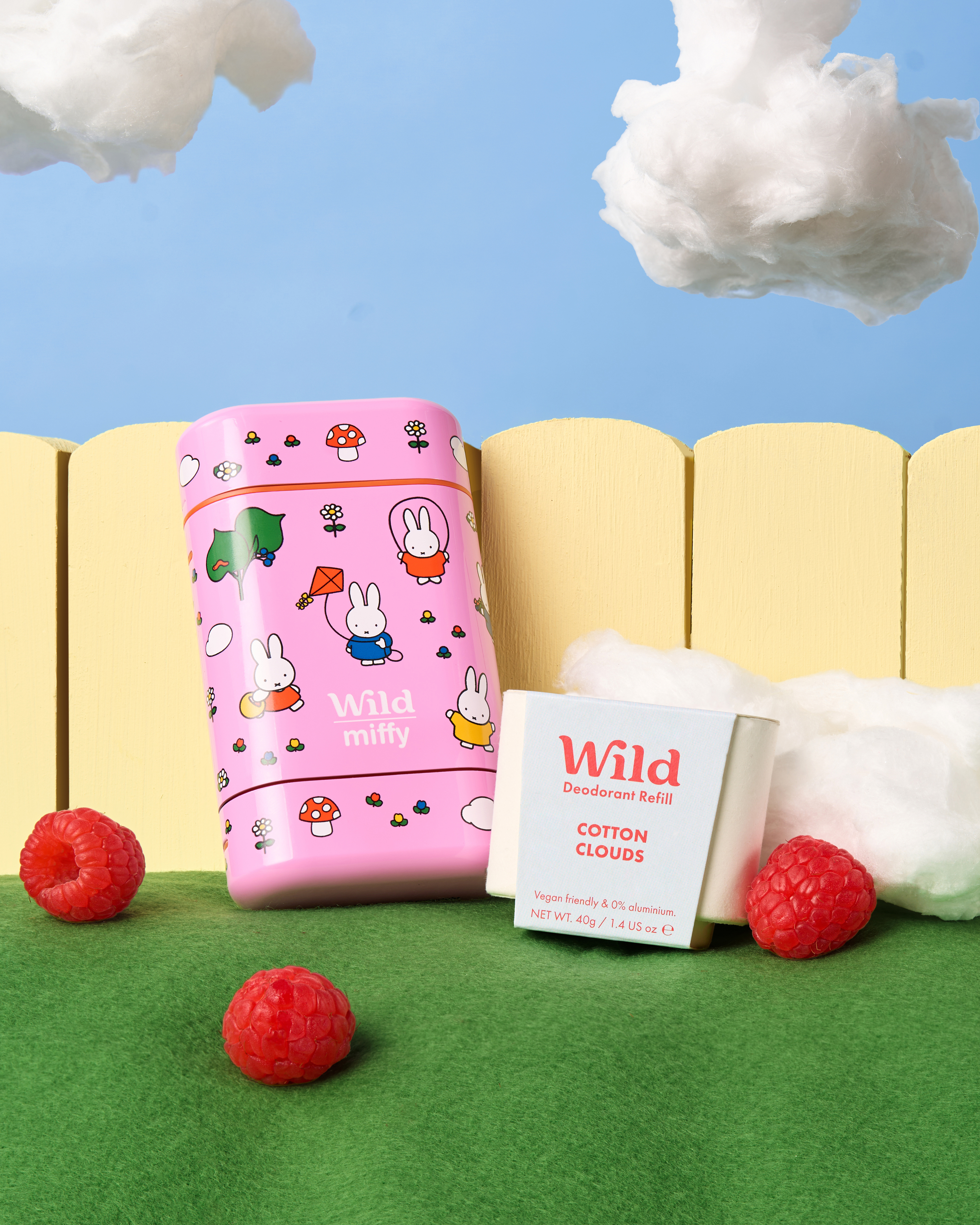 Caption: a pink box sitting on top of a lush green field