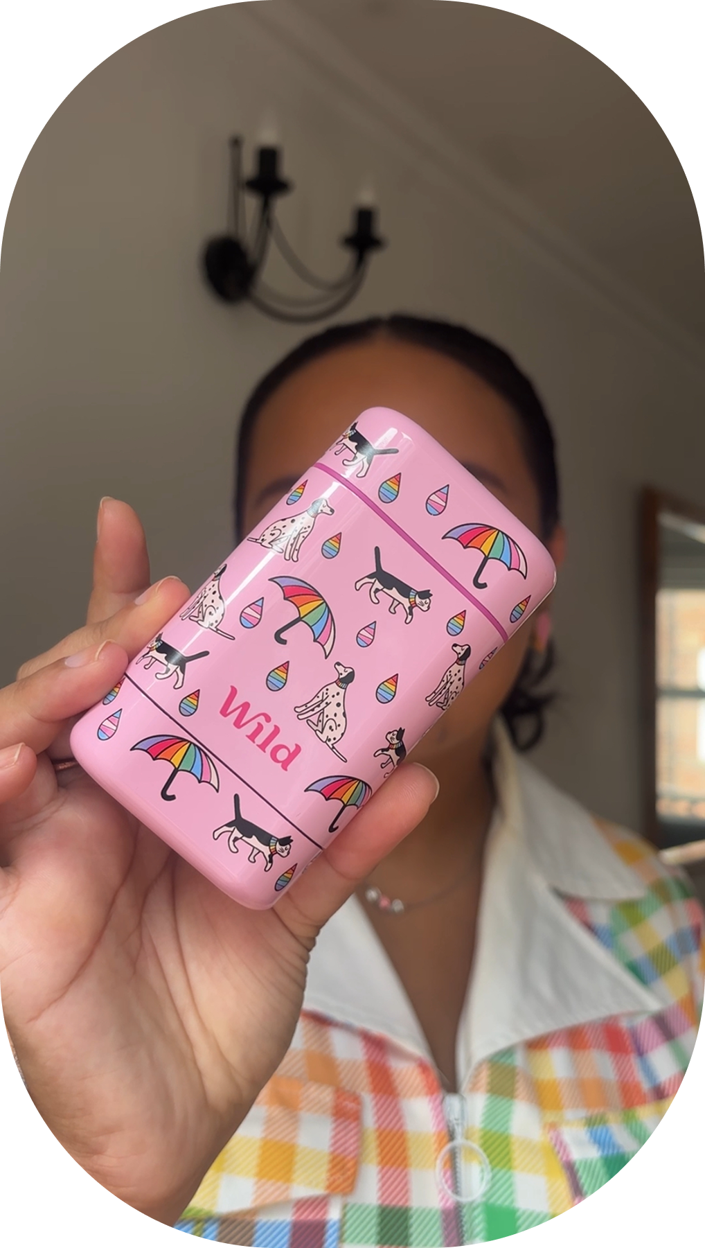 Caption: a woman holding a pink case with umbrellas on it