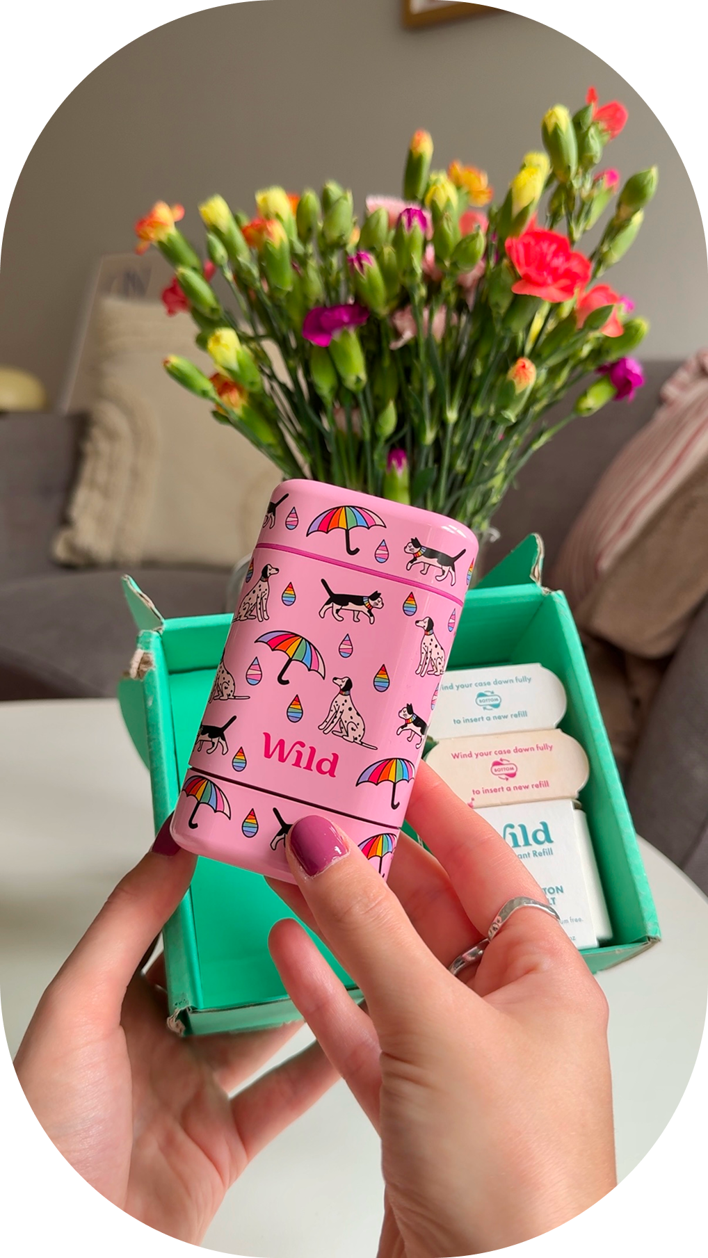 Caption: a person holding a pink box with a unicorn pattern on it
