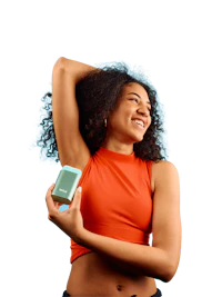 Caption: a woman in an orange top holding a cell phone