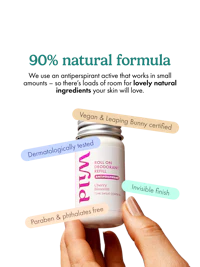 Caption: a hand holding a jar of vitamin supplement