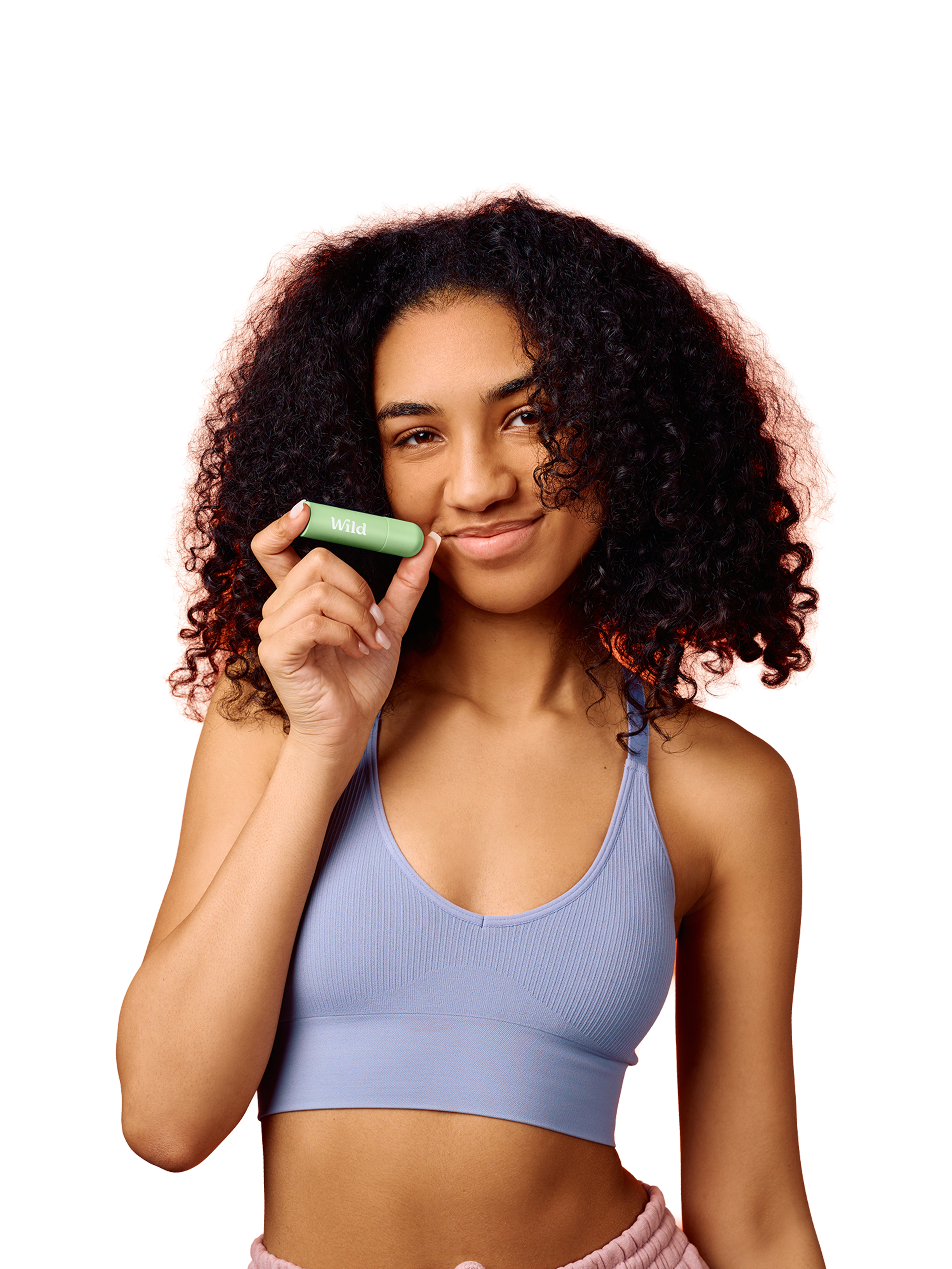 Caption: a woman in a sports bra holding a green object