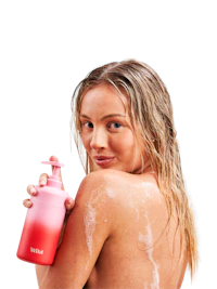 Caption: a woman holding a bottle of lotion in her hand