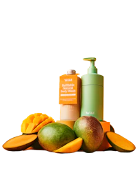 Caption: a bottle of lotion sitting next to a pile of fruit