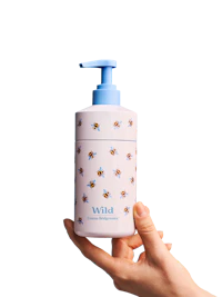 Caption: a hand holding a white and blue bottle with bees on it