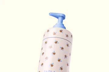Caption: a baby bottle with a blue handle and bees on it