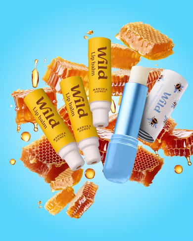 Caption: a blue bottle of lip balm surrounded by honey and honeycombs