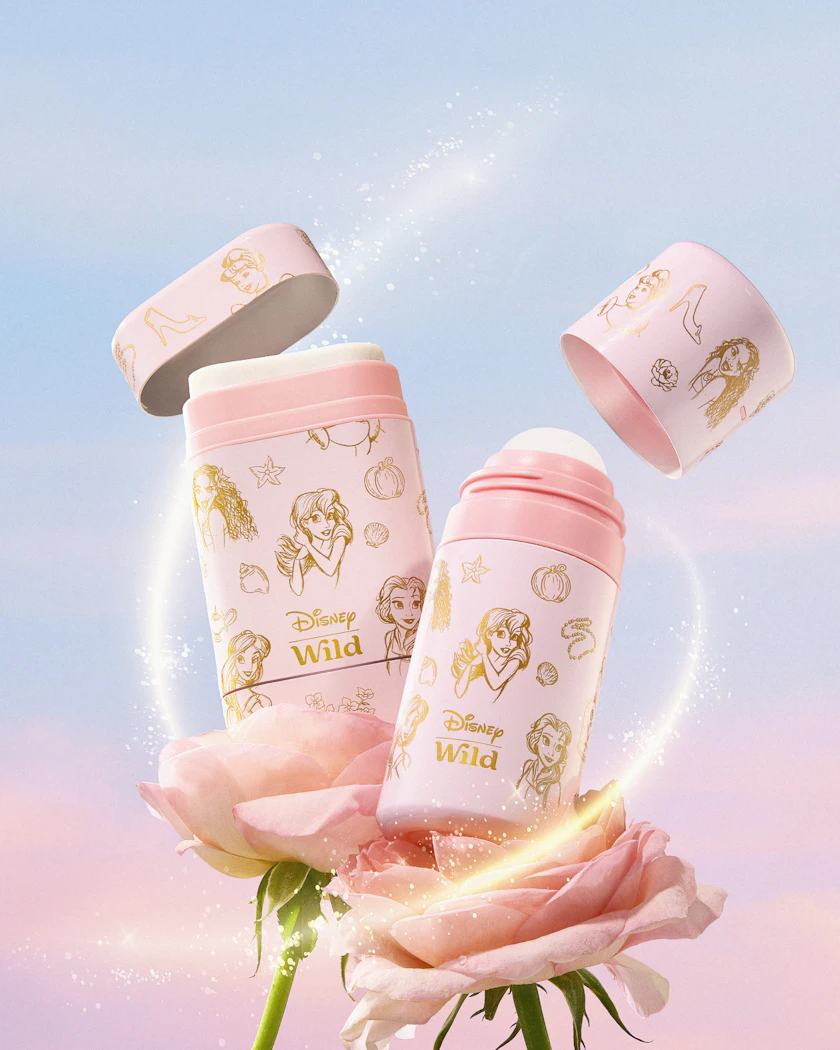 Caption: a pink flower with two pink baby bottles on top of it