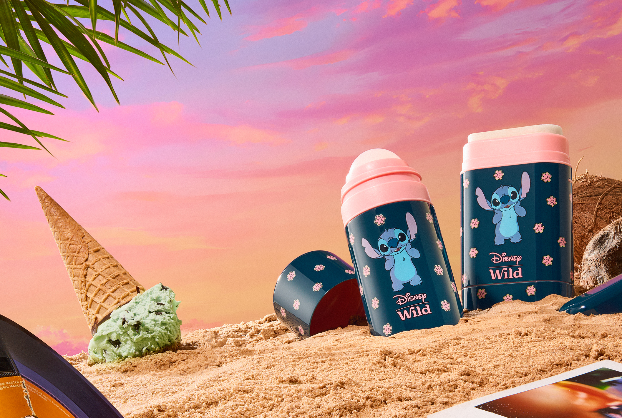 Caption: a couple of cups sitting on top of a sandy beach