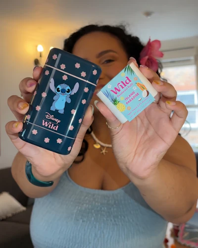 Caption: a woman holding a cell phone in her hands