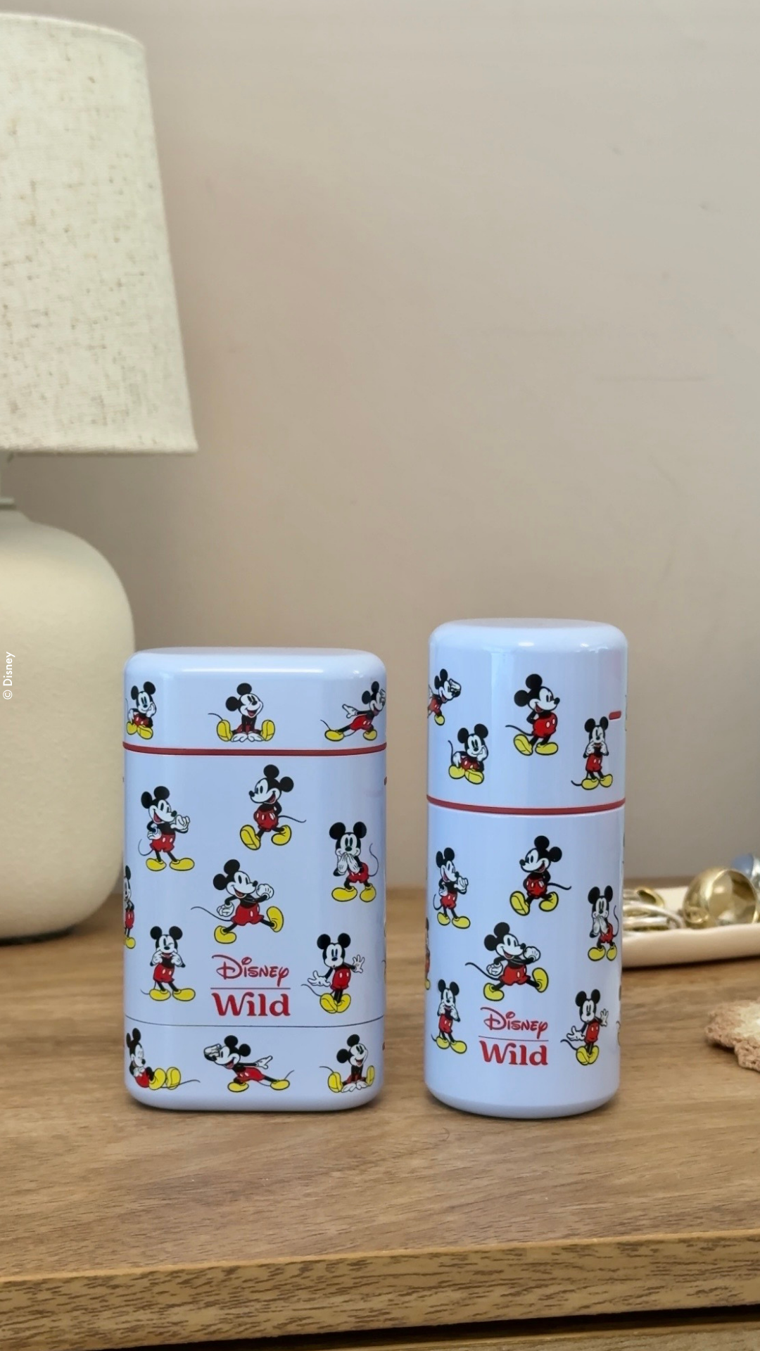 Caption: a couple of cups sitting on top of a wooden table
