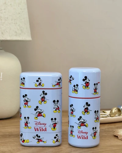 Caption: a couple of cups sitting on top of a wooden table