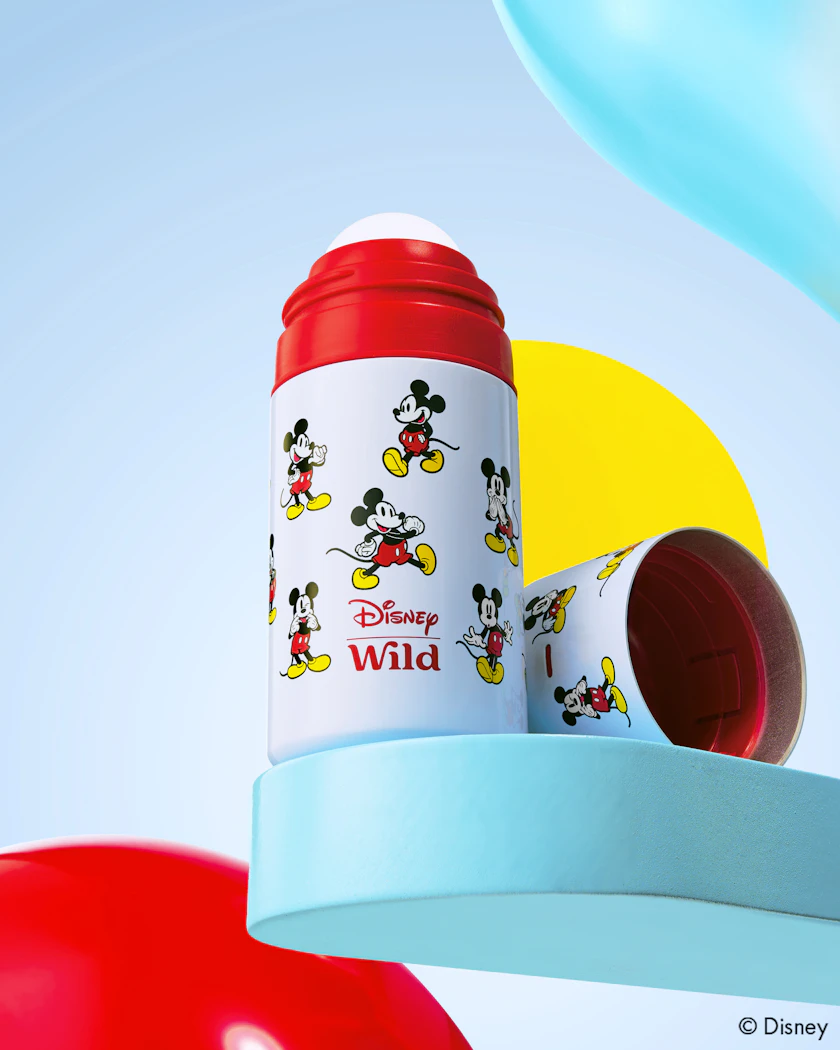 Caption: a red and white bottle with mickey mouse on it