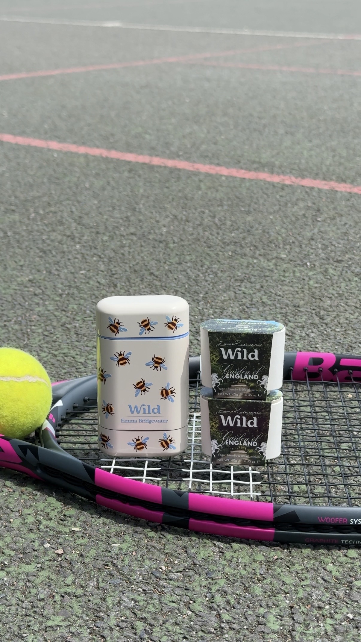Caption: a tennis racket with a cup of coffee and a ball on it
