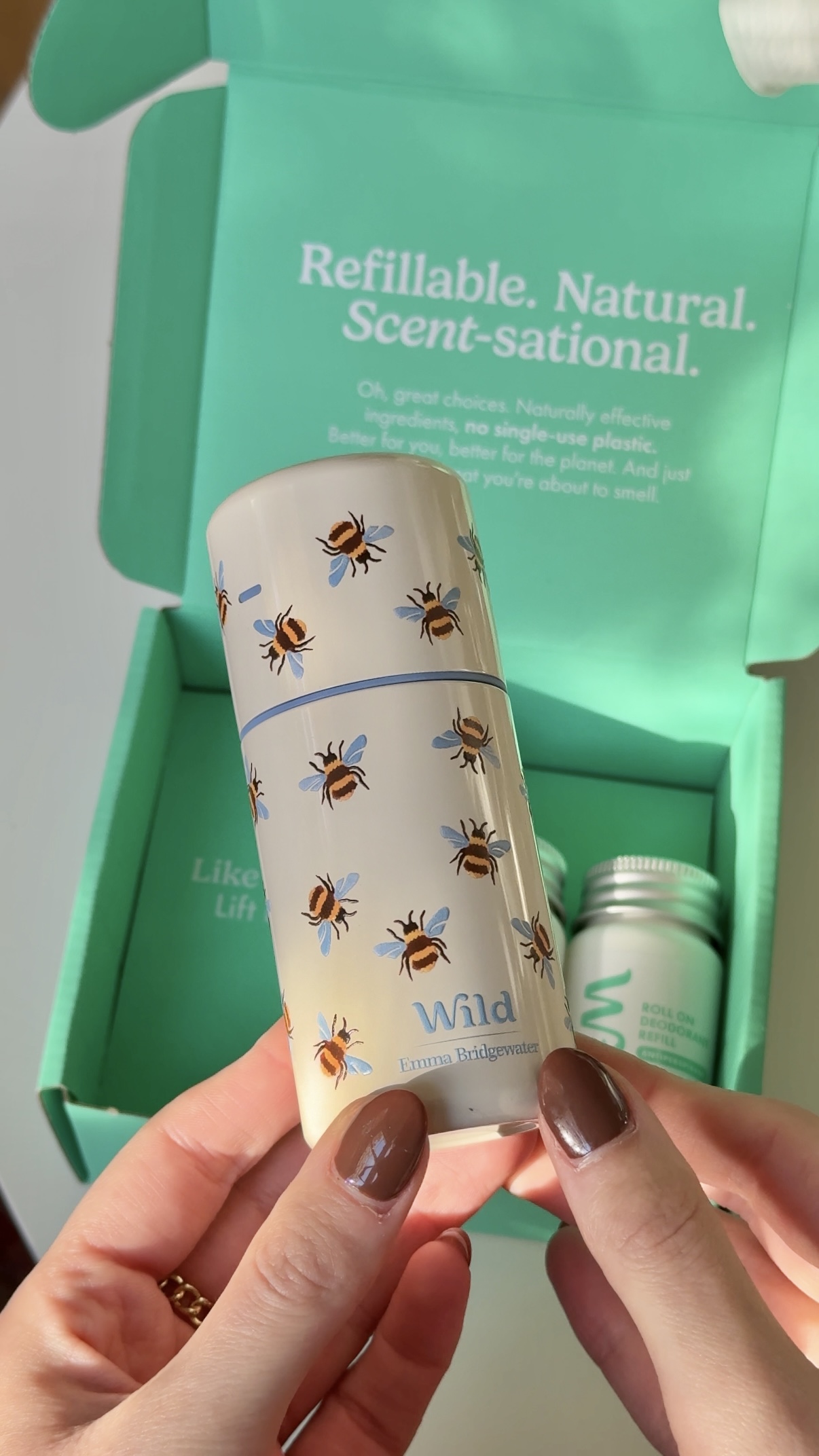 Caption: a woman holding a cup with bees on it