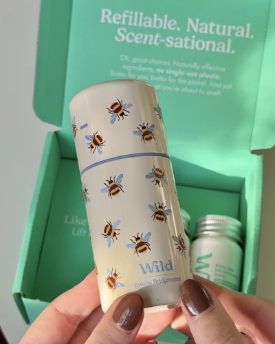 Caption: a woman holding a cup with bees on it