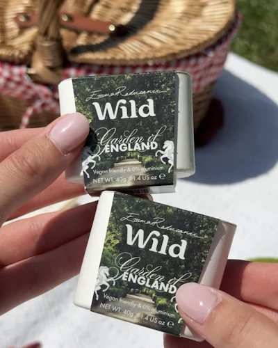 Caption: a person holding two small business cards in their hands