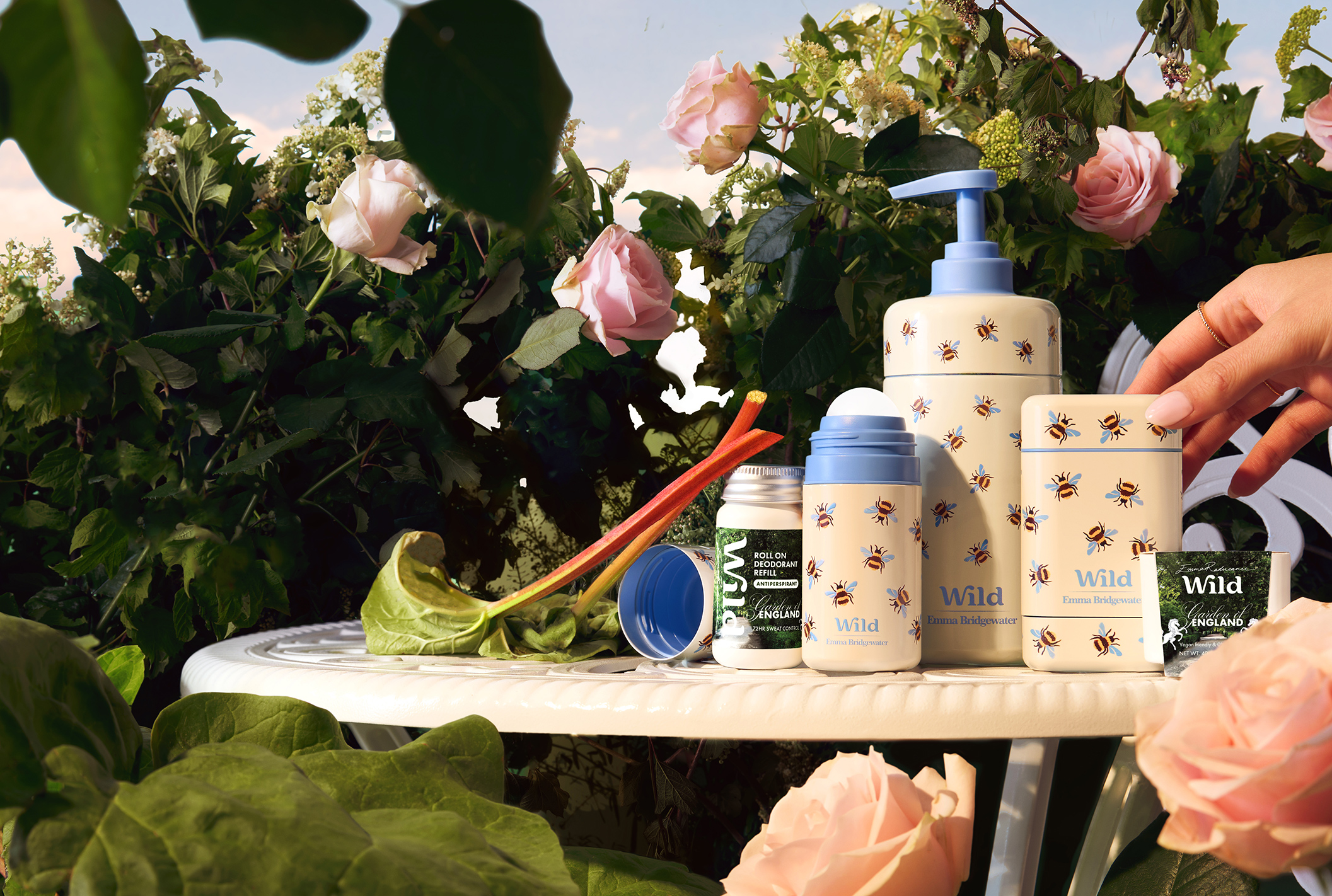 Caption: a table topped with bottles of hand sanitizers and flowers