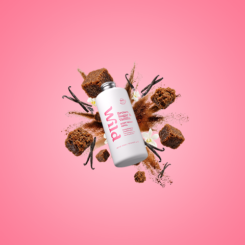 Caption: a pink background with a bottle of body lotion on top of it