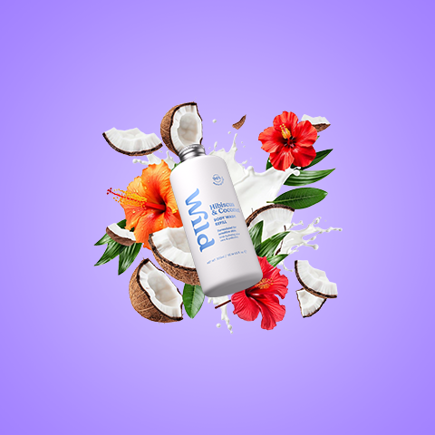 Caption: a bottle of lotion surrounded by flowers and coconuts